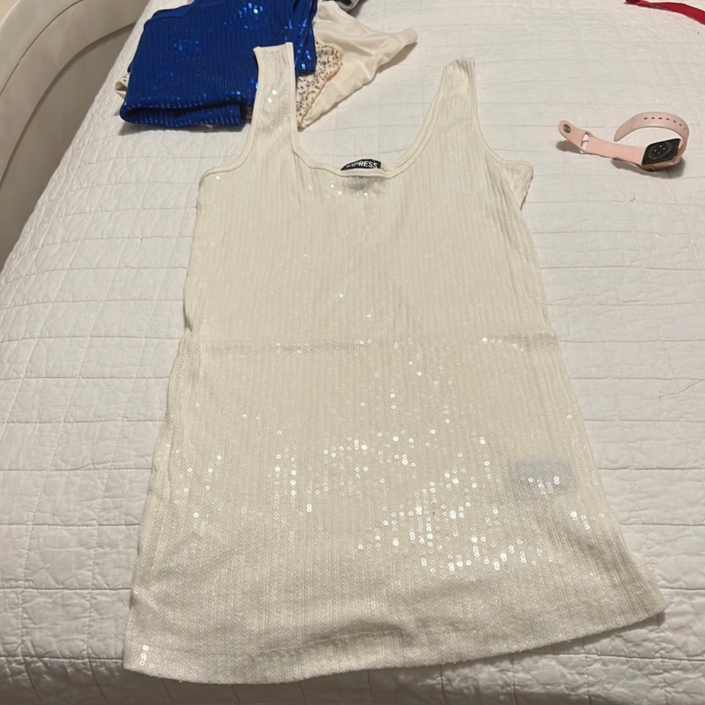Cream colored sparkly tank top measures 12 across and 21 in length